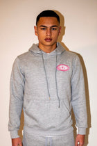 PR1VATE Kapuzenpullover mit rosa Emblem